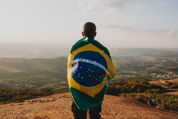 Man holding the flag of Brazil