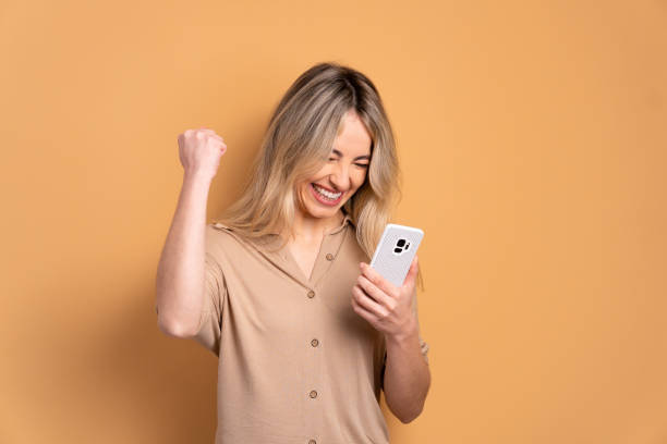 woman raising arms and celebrating