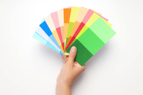 istock Female hand holding color palettes on white background 1504480462