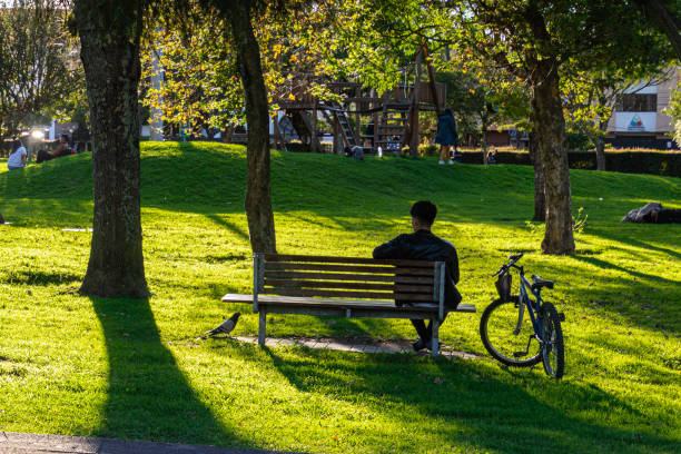 Cyclist having a nap in the park.