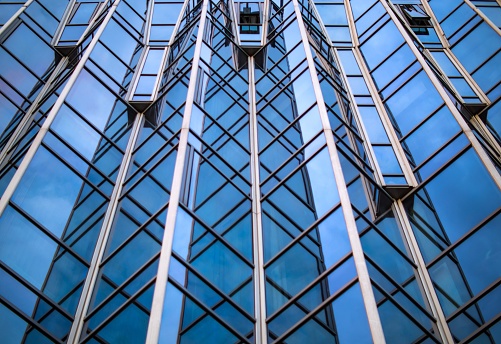 An HDR enhanced image of the Port of Liverpool and Liver buildings reflected in the window of an office block in the Albert Dock.