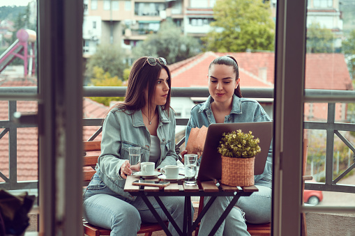 Coffee Break By Beautiful Females With Laptop On Balcony