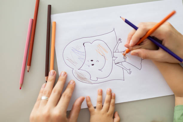 istock Mother and daughter painting a drawing 1504534026