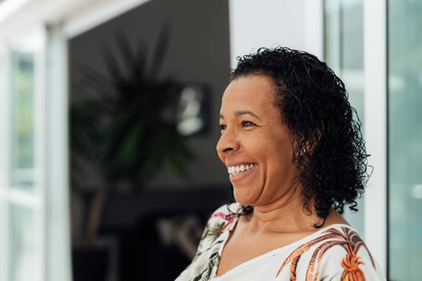 istock Latin woman smiling at home 1504549464