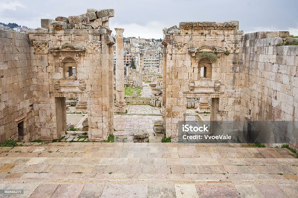 Artemis temple in ancient city  Gerasa to modern Jerash view through antique Artemis temple in ancient city  Gerasa to modern Jerash , Jordan Altar Stock Photo