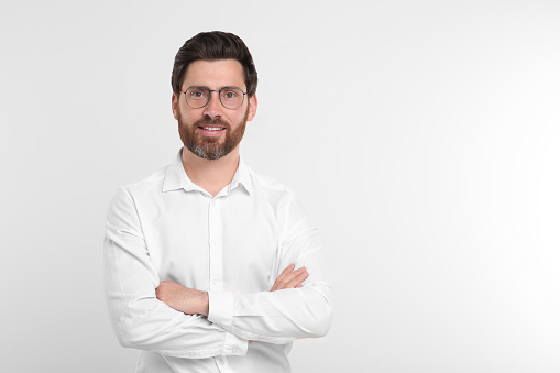 Portrait of handsome man in glasses on white background. Space for text