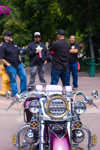Santa Fe, NM: Low riders chat near a lowrider bike (cruiser) on the historic Santa Fe Plaza on the annual (June) Lowrider Day.
