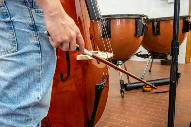 Real life young music students during rehearsals. Musical instruments and music stand with stave. stock photo