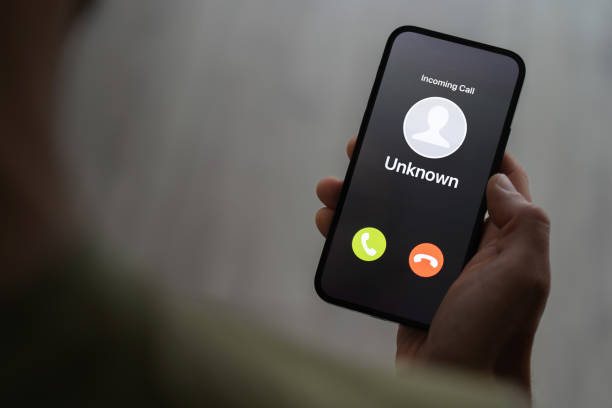 istock Scam call concept, person holding ringing phone with unknown caller, fraud attempt 1504615133