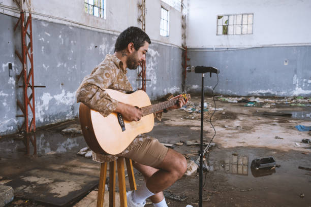 istock Young Musician Playing Guitar 1504621964