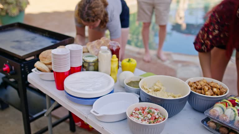 Friends Setting Up Table With Food