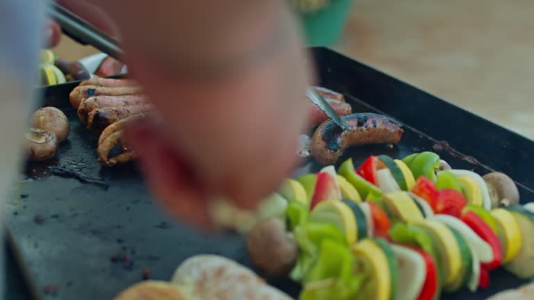 Close Up Of Man Grilling Hotdogs