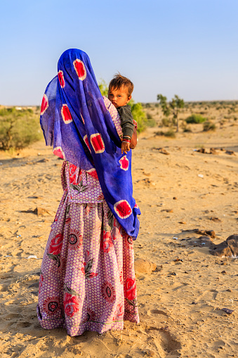 Young Indian woman with her baby. Thar Desert, Rajasthan, India.