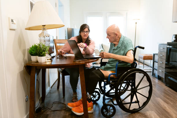 istock Senior man with disabilities talks with a social worker 1504675426