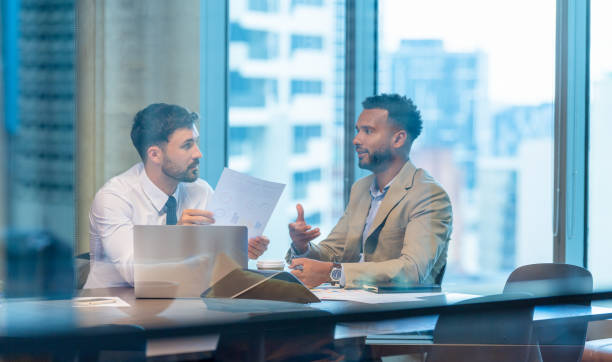 istock Two business men meeting in a modern  office. 1504677493