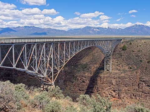 The Rio Grande Gorge bridge crosses the river 10 miles outside Taos New Mexico. The arch bridge with a 1200 foot span and some 600 feet above the river is the 10 highest bridge in the USA.