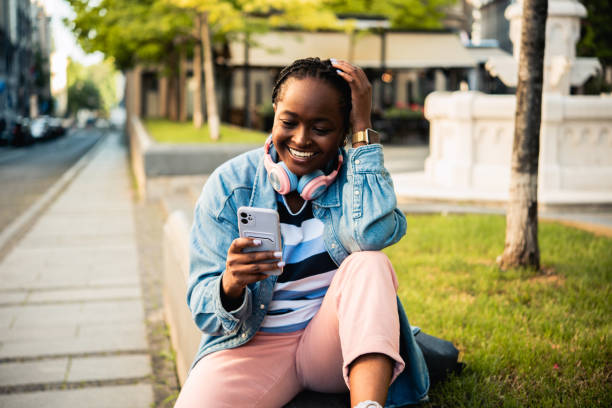 istock Happy woman using smartphone outdoors 1504734715
