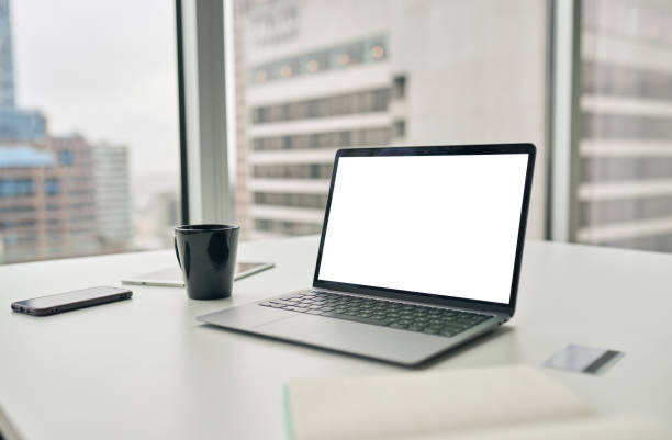 istock Laptop computer with white mock up empty blank screen on desk in office. 1504764061