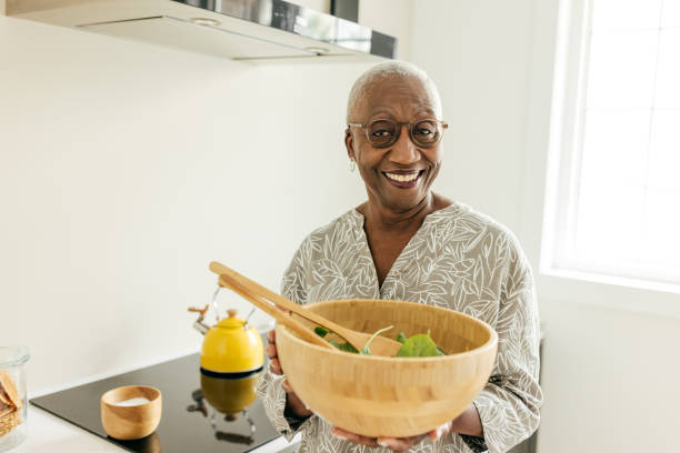istock Senior women holding a salad bowl 1504764177