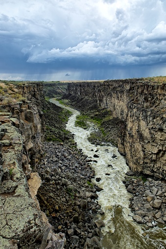 The Malad River winds through the famous Malad Gorge under a dramatic sky in southern Idaho.