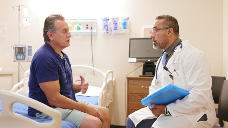 Doctor greets his next patient, a senior mixed race man