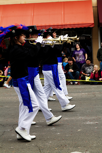 Boys And Girl Playing Trumpets White Marching In Small Town Parade In Uniforms