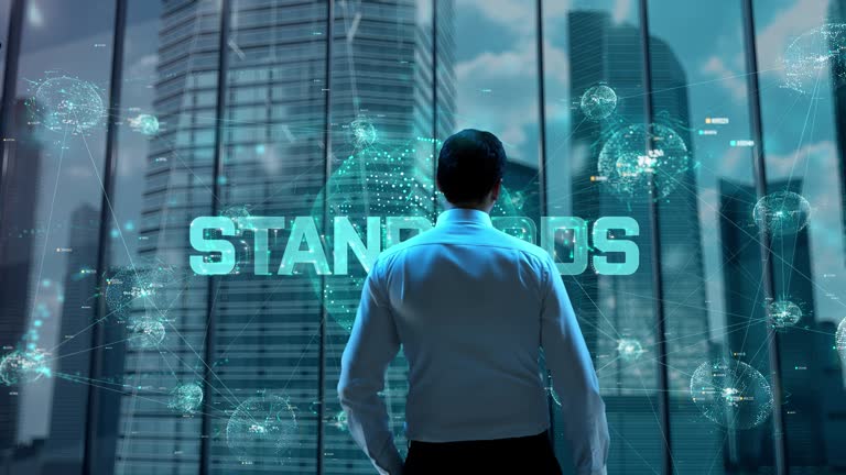 Standards. Businessman Working in Office among Skyscrapers. Hologram Concept