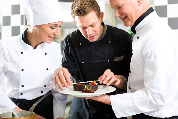 istock A chef evaluating the dessert dish prepared by sous chef 150484410