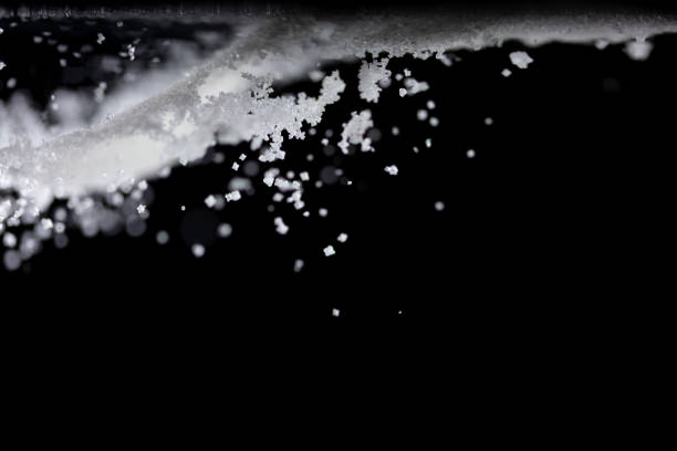 istock Salt powder pour fall in bowl, white Salt crystal cook abstract cloud fly. Ground salt splash in air, food object element design. Black background isolated selective focus blur 1504875491