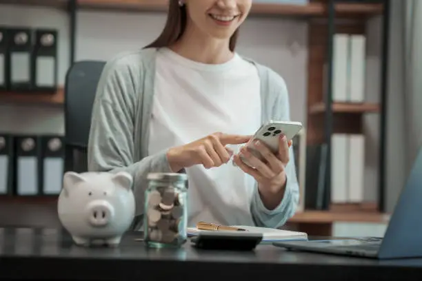 Close up young woman saving money for household payments coin,  piggy bank, mutual fund, mixed fund, Super Saving Funds (SSF), Retirement Mutual Fund (RMF), Net Asset Value (NAV), dividend, Inflation