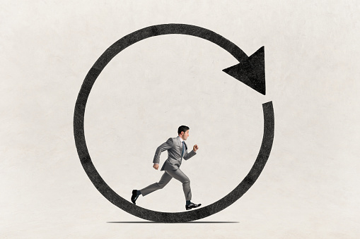 A businessman runs in a circle.