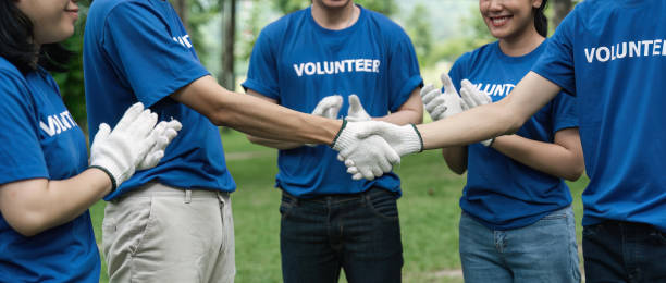istock Environmentalist volunteers planting new tree and handshaking 1504975265