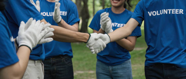 istock Environmentalist volunteers planting new tree and handshaking 1504975279