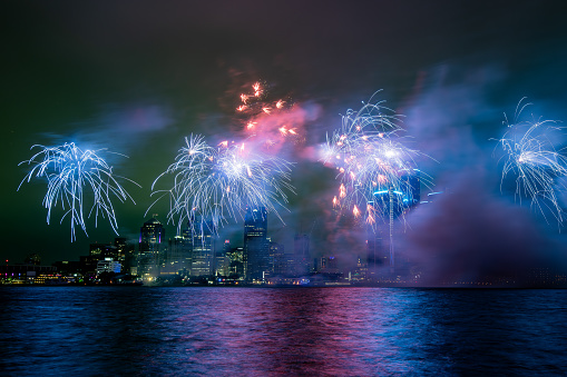Detroit, Michigan Ford fireworks taken from Windsor, Ontario on the Detroit river with the downtown skyline visible behind the fireworks.