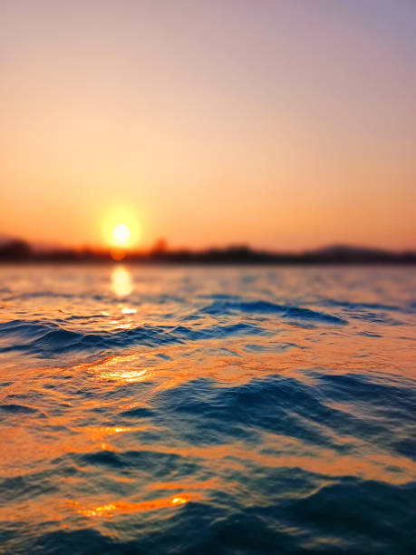 istock Sea wave splash, sunset blurred bokeh background, ocean water surf ripple texture, sunrise soft focus, tropical island beach dawn, sundown orange sun shine reflection, summer holiday, vacation, travel 1504991185