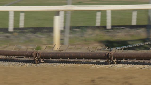 Close-Up Shot of a Harrow Tilling the Surface of a Horse Racetrack