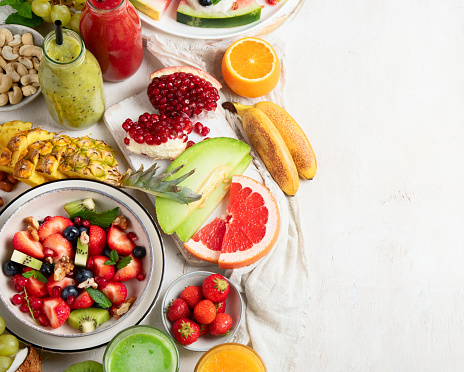 Summer fruits assorted on white background. Fresh raw food concept. Copy space