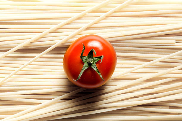 surowy makaron i świeży pomidor - teigwaren zdjęcia i obrazy z banku zdjęć