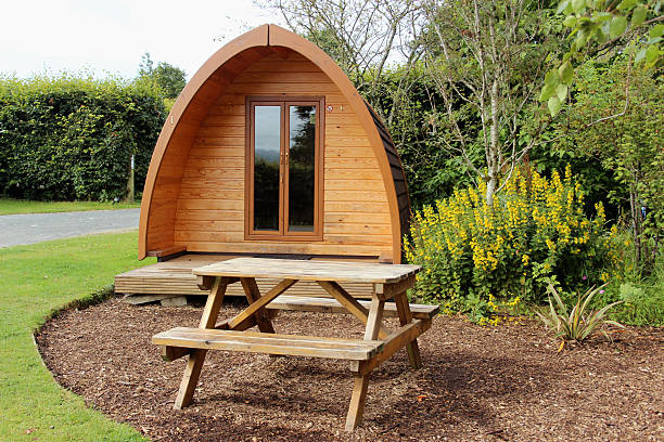 A luxury camping pod with a picnic bench outside in Devon.  A new alternative option for camping in style.