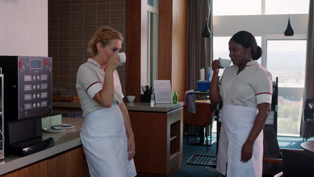 Hotel maids greeting each other on break