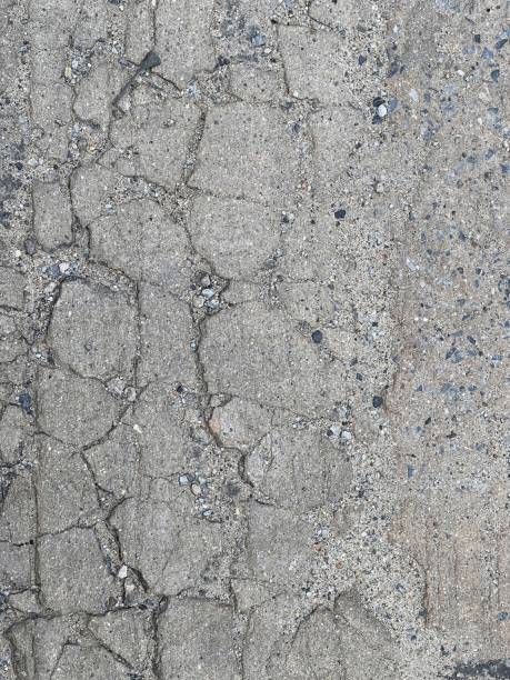 istock a photography of a black and white fire hydrant on a sidewalk,d concrete surface with cracks and small stones 1505067962