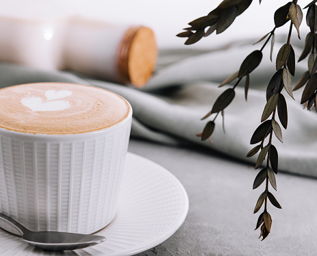 Close up of Cup of coffee with heart flower painted on foam