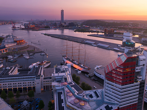 Aerial view of Lilla Bommen and the harbor districts of Gothenburg at sunset. In the background is the Karlatornet skyscraper under construction.