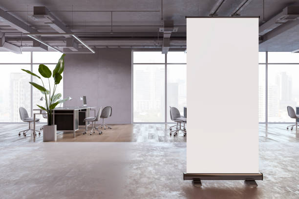 istock Modern coworking office interior with empty white roll-up banner, panoramic window and city view, equipment and furniture. Mock up, 3D Rendering. 1505177899
