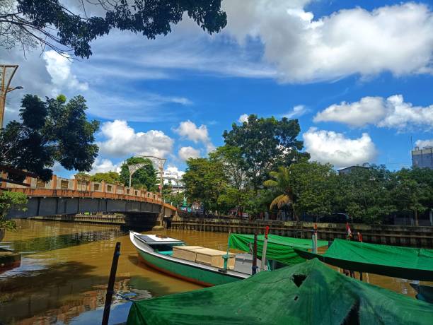 View of boat, river, bridge, sky, cloud and trees