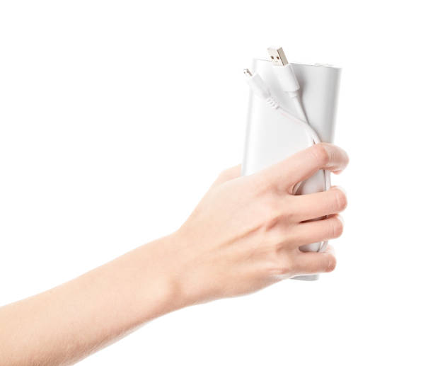 istock Silver power bank on hand isolate. Power bank for charging mobile devices. Smart phone charger with power bank. battery bank. External battery for mobile devices. 1505185151