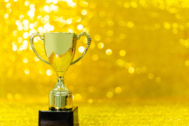 Golden trophy on shiny background.
