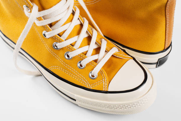 istock Yellow sneakers on white background with copy space. Youth shoes. 1505191086