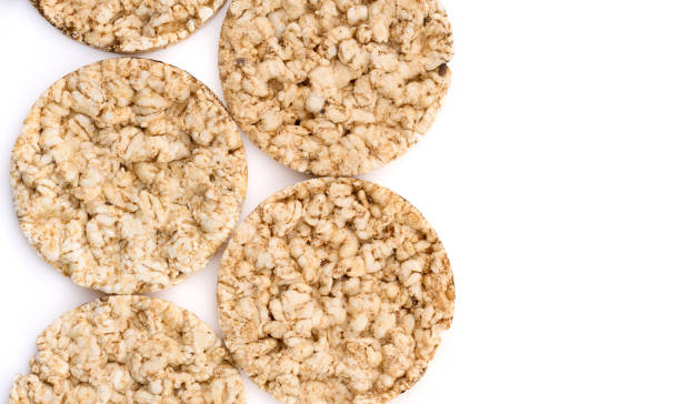 istock Puffed rice bread isolated on white background. Rice cakes. Round diet crispbreads on a white background. Round shaped cereal bread, healthy food without yeast 1505203297