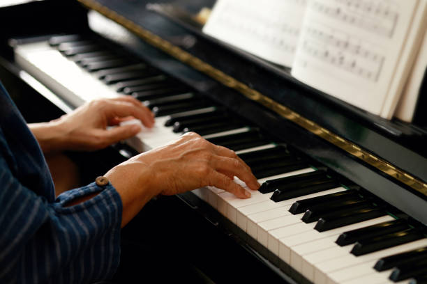 istock Senior woman playing piano in her home. 1505216247